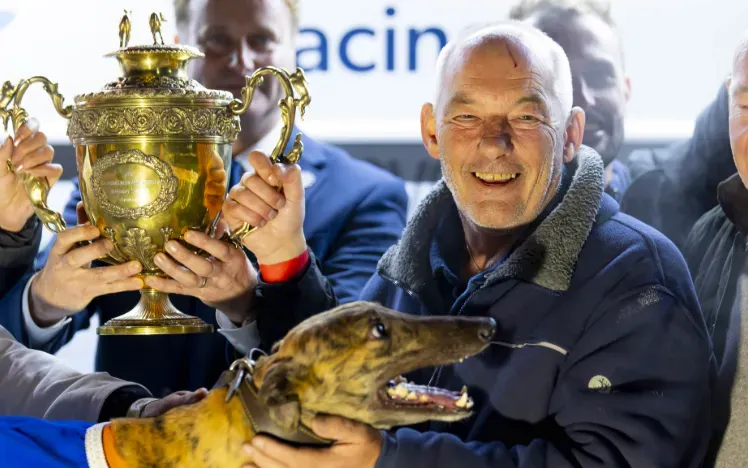 Proud owner poses with their winning greyhound at Dunstall Park greyhounds