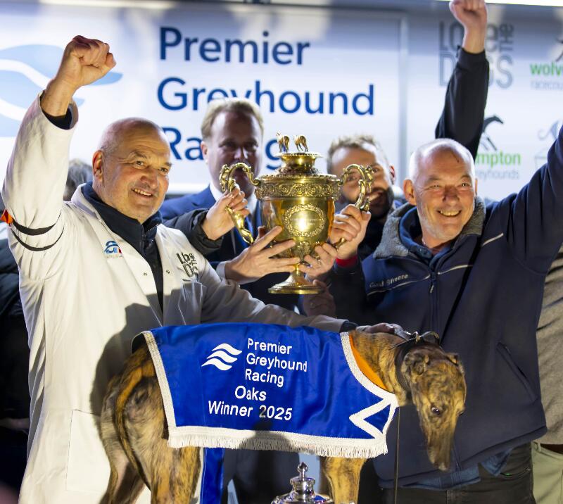 A winning group cheering with their champion greyhound at Dunstall Park
